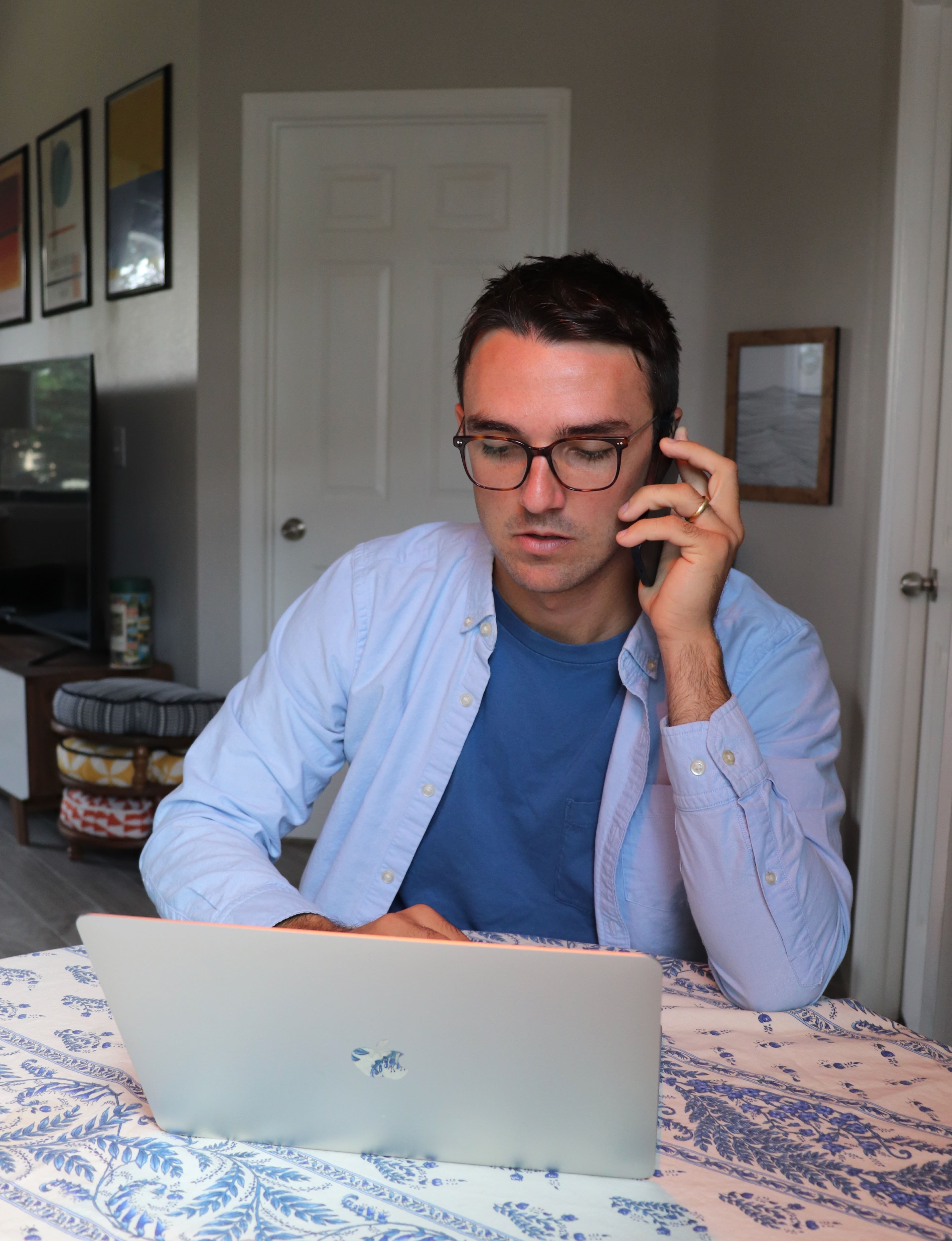 man talking with a phone and laptop